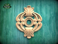 a decorative wooden carving on a green background.