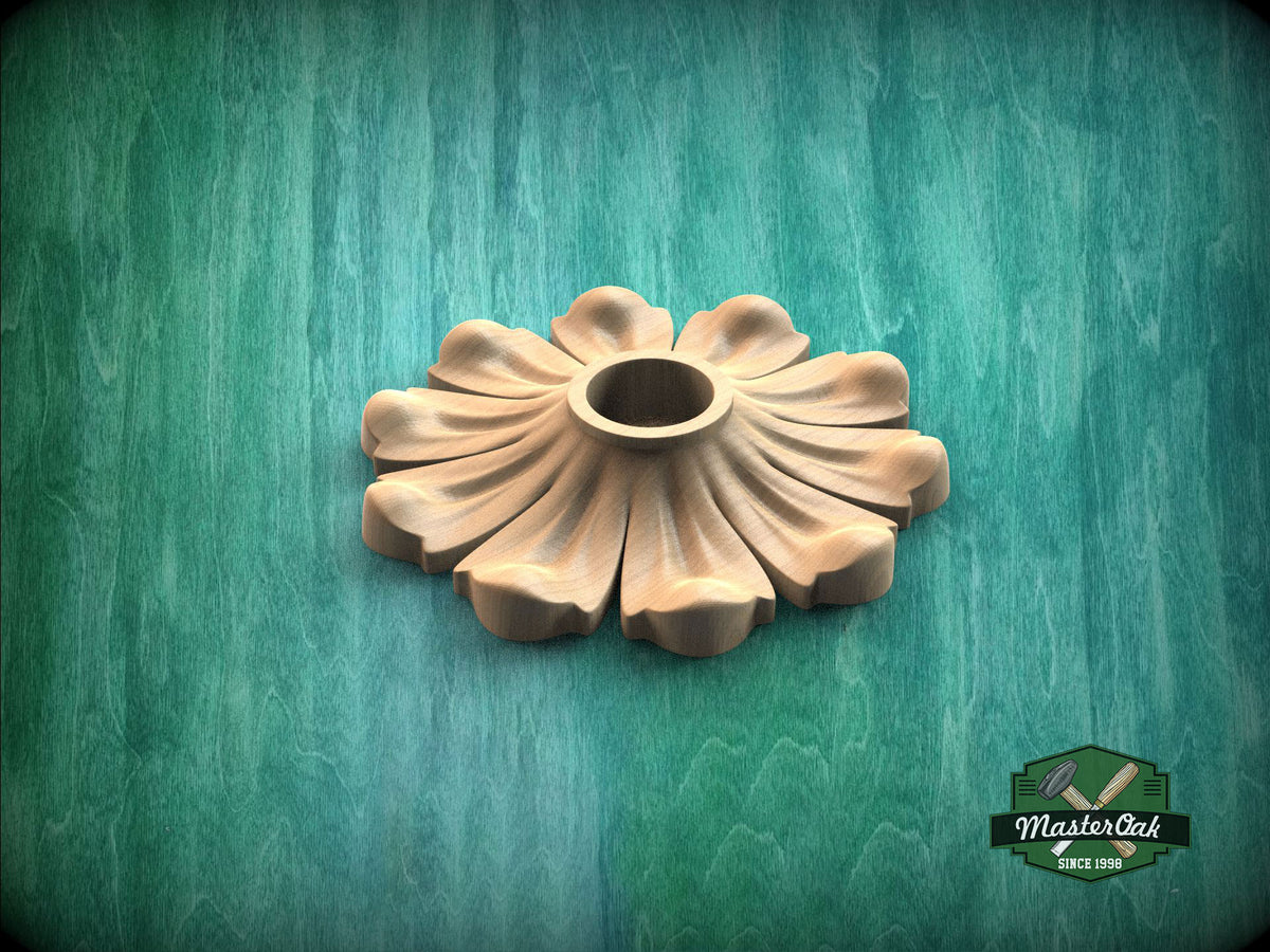 A wooden flower-shaped object is displayed against a green background.