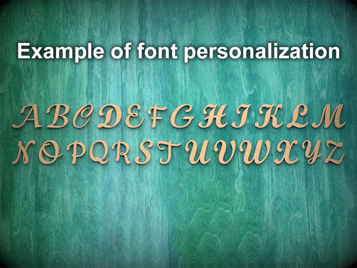 a close-up of a wooden surface with the letters of the alphabet arranged in a decorative font, representing an example of font personalization.