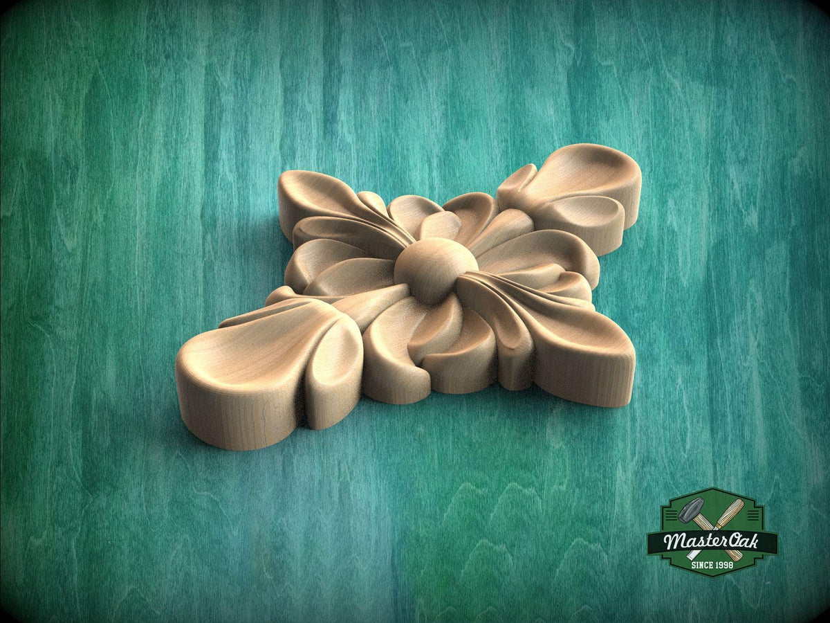 A wooden carving of a flower-like design is displayed against a green background.