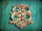 a beautifully carved wooden piece with intricate designs, displayed against a green background.
