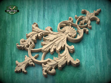 Load image into Gallery viewer, a beautifully carved wooden piece with intricate floral and leaf designs, set against a green background.
