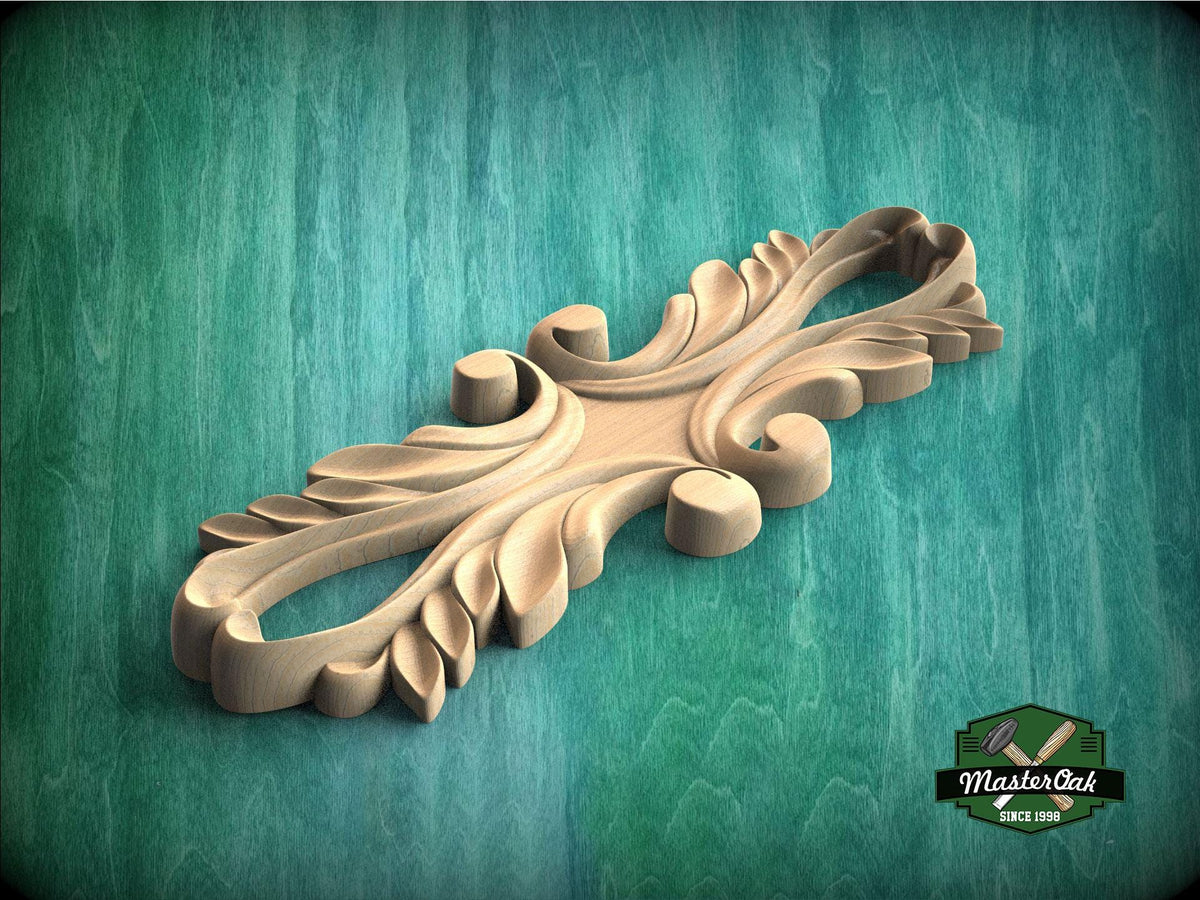 A wooden carving with intricate, organic shapes sits on a green textured surface.