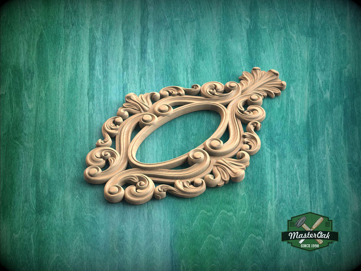 A decorative wooden frame with intricate scrollwork and floral patterns is displayed against a green wooden background.