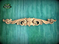 a wood carving on a green wall