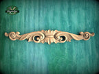a wood carving on a green wall