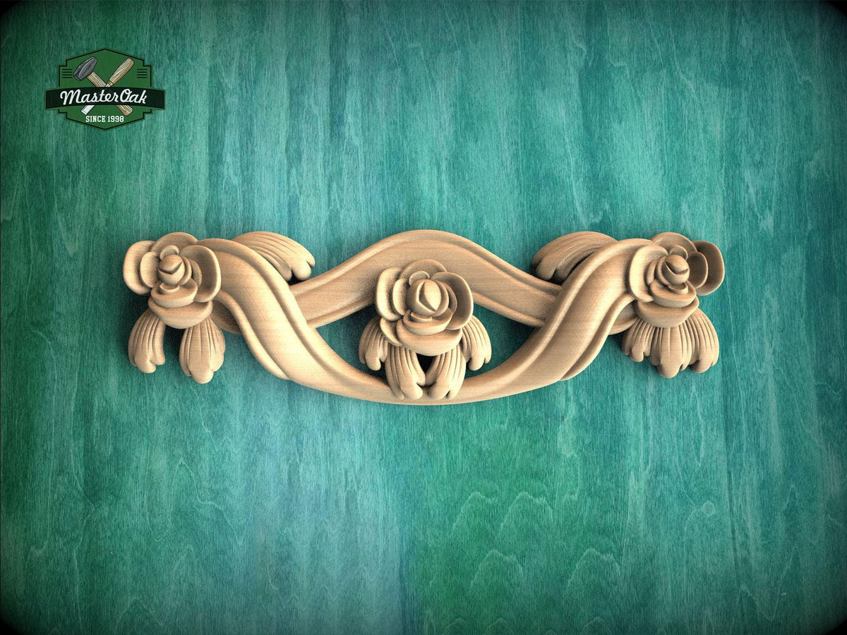 A decorative wooden carving of a floral design on a green background.