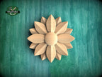 A wooden flower-shaped object is centered against a green background.