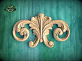 a decorative wooden carving on a green background.