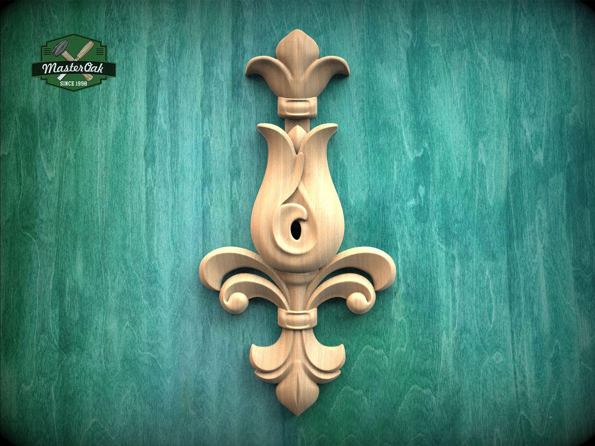 a wooden ornamental piece with a floral design, mounted on a green textured wall.