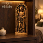 a wooden statue of a winged figure holding a torch, displayed on a wooden shelf or table.