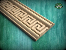 Load image into Gallery viewer, a wooden carving with a geometric pattern, placed on a green wooden surface.
