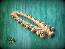 Load image into Gallery viewer, A wooden decorative piece with a leaf-like design is displayed against a green background.
