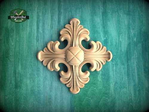 a decorative wooden piece with an intricate design, placed against a green background.
