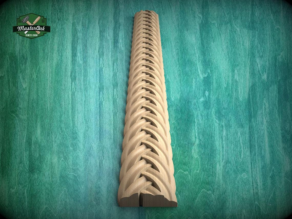 a wooden carving of a decorative scrollwork design on a wooden surface.
