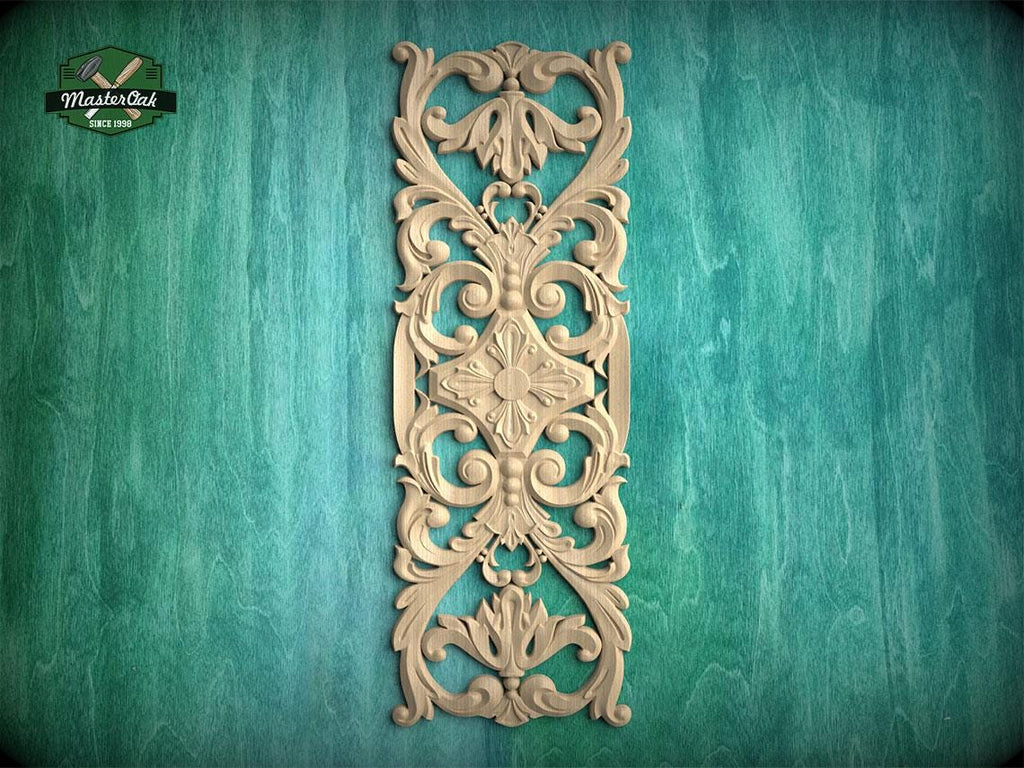 an ornate, carved wooden panel with intricate floral and scroll designs, mounted on a green wooden surface.