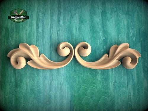 a wood carving of two wavy scrolls on a green background