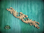 a wood carving of an ornate design on a green background