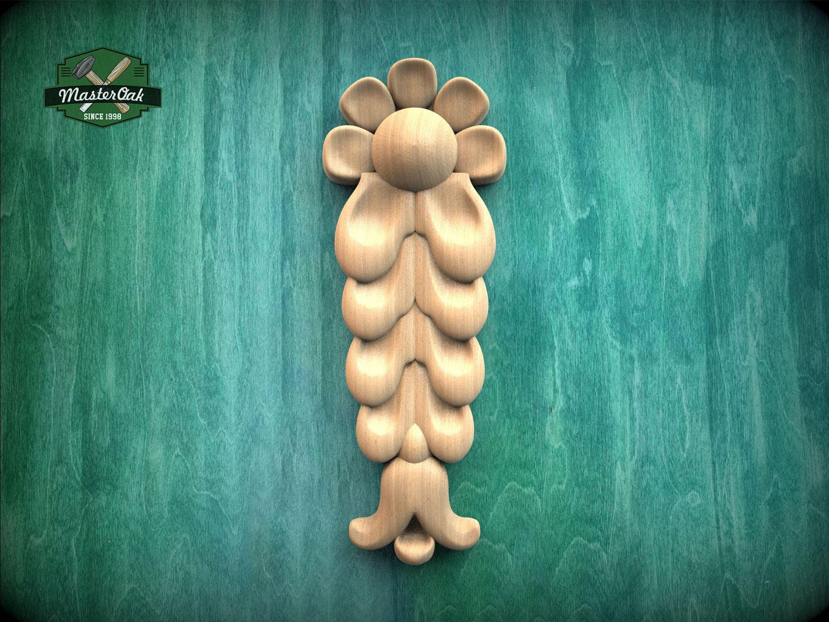 A wooden carving of a flower-like design is displayed against a green textured background.