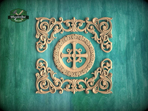 an ornate, carved wooden design with intricate scrollwork and a central motif, set against a teal background.