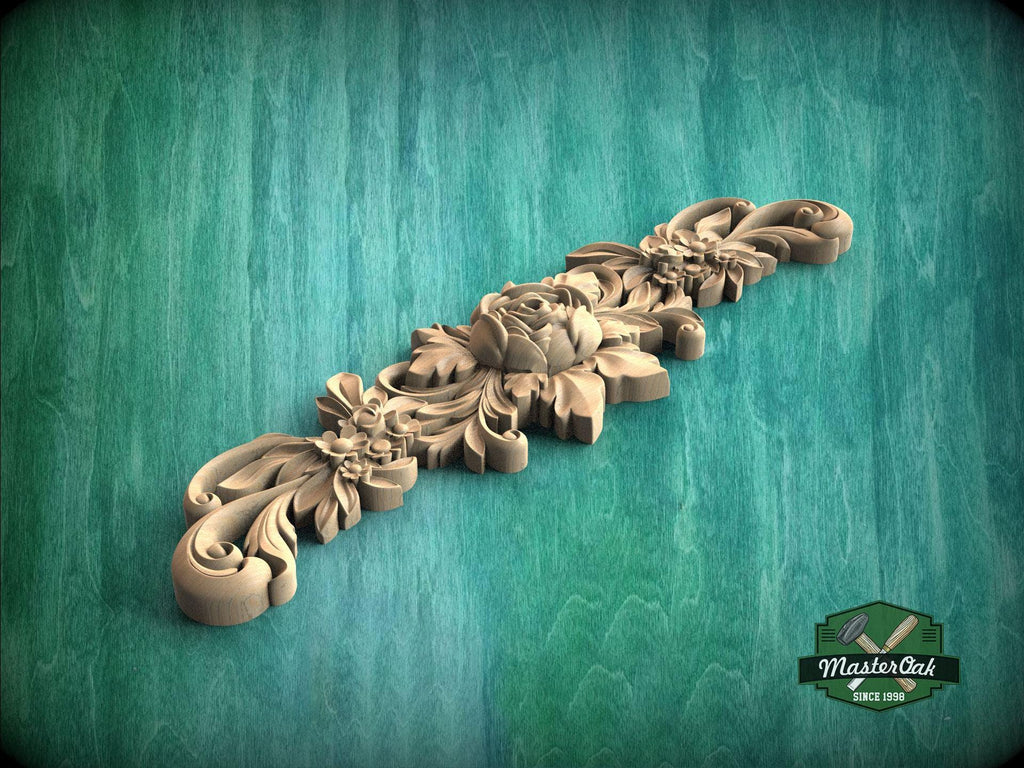 A decorative wooden carving with intricate floral and leaf designs is displayed against a green background.