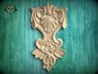 a decorative wooden carving on a green background.