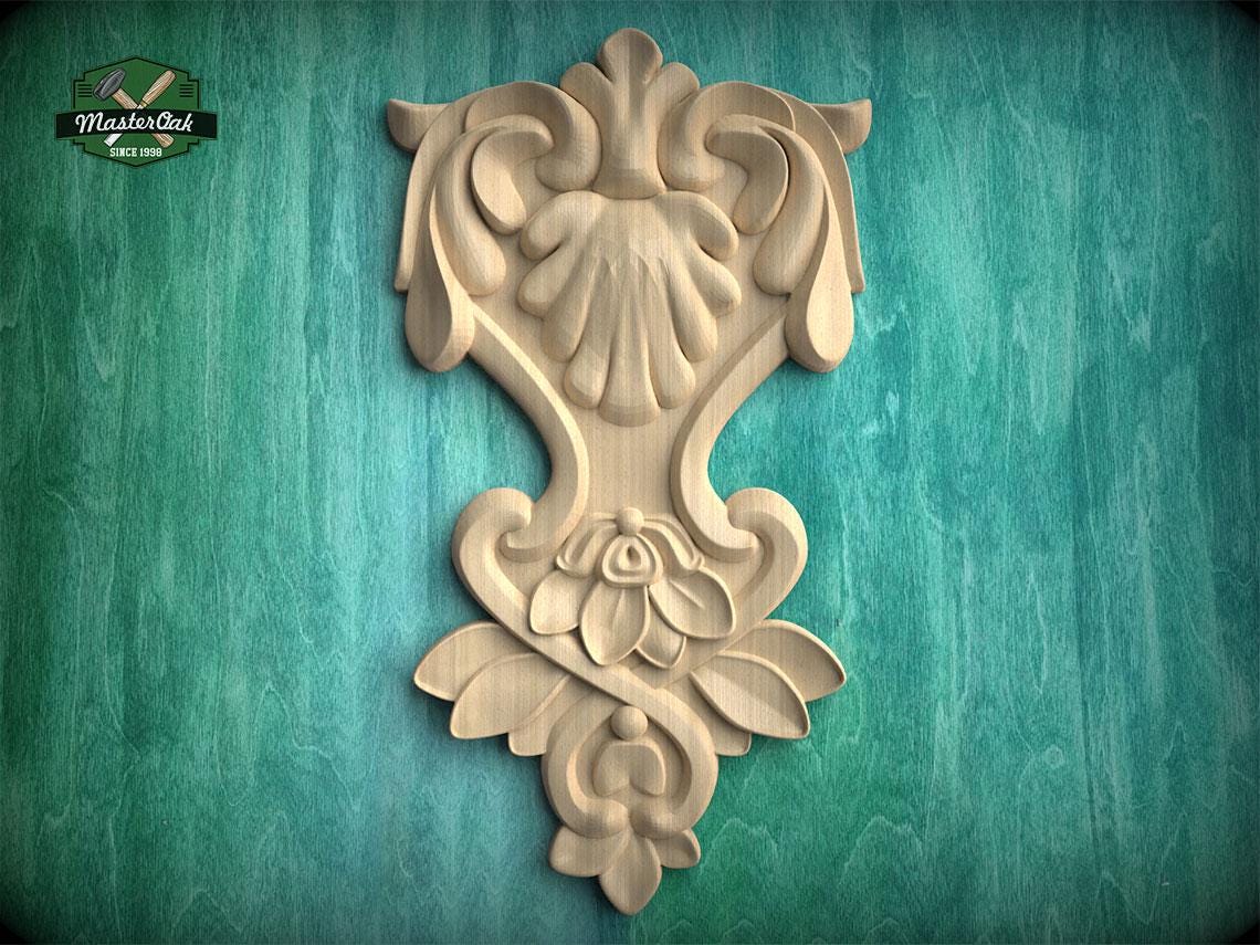 a decorative wooden carving on a green background.