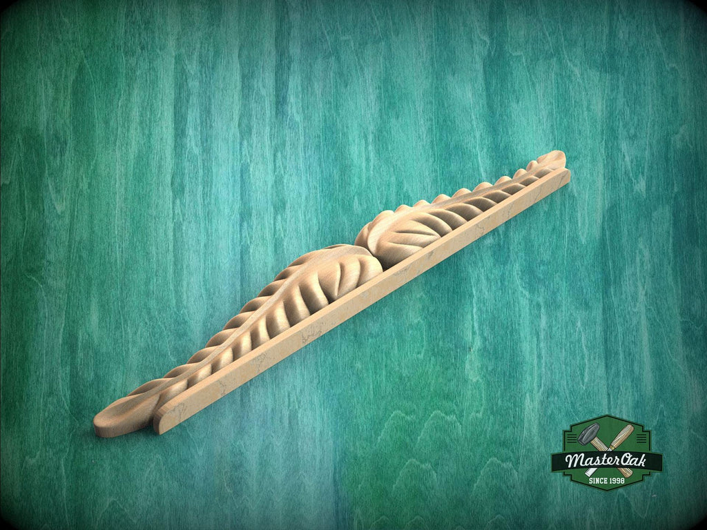 A wooden carving with intricate designs is displayed against a green background.