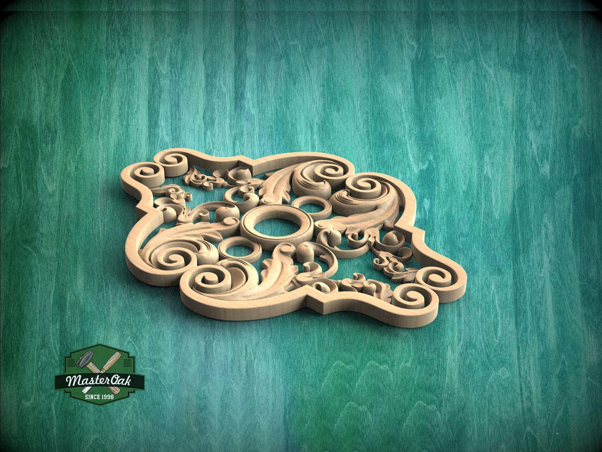 A decorative wooden carving or panel with intricate swirling patterns and shapes, displayed against a green textured background.
