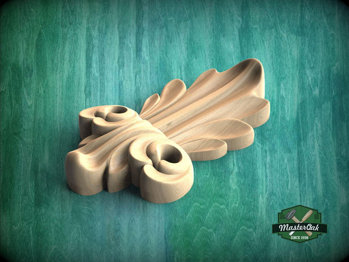 A wooden carving with a leaf-like design is displayed against a green background.