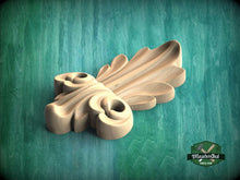 Load image into Gallery viewer, A wooden carving with a leaf-like design is displayed against a green background.
