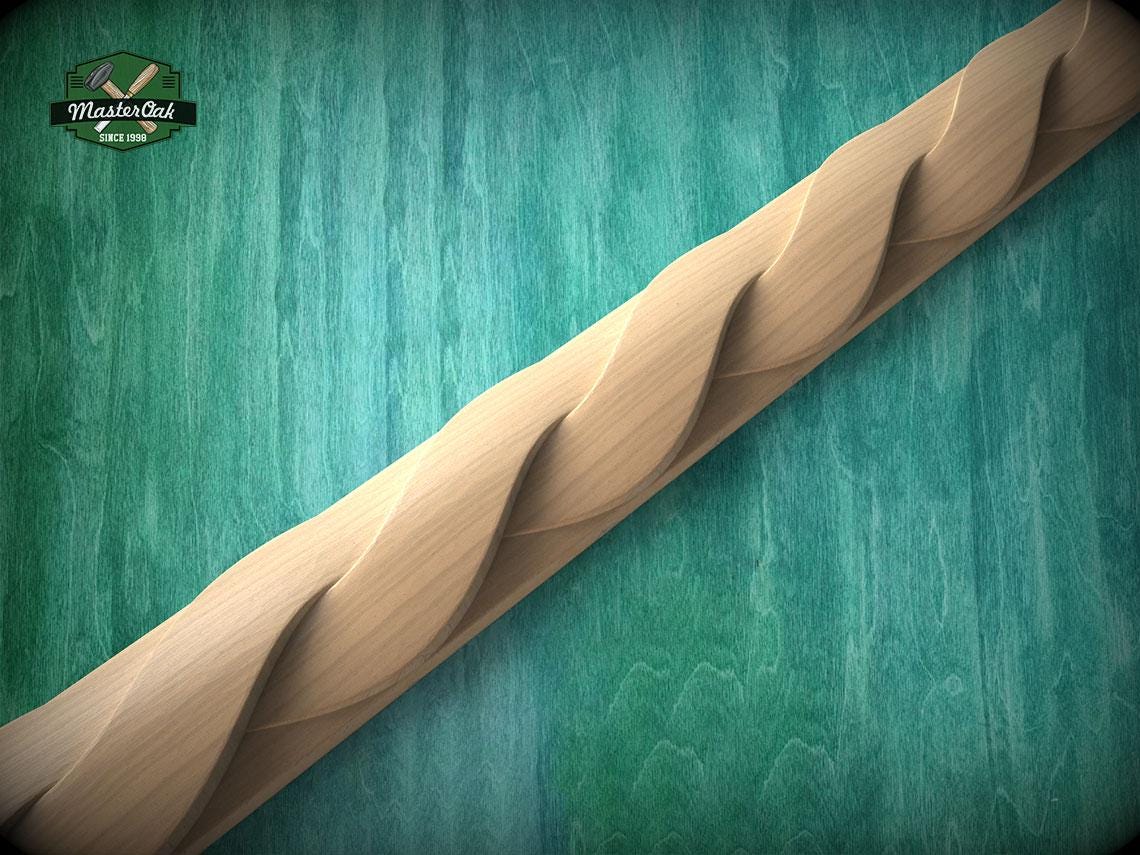 A wooden carving with a curved, wavy design is displayed against a green background.