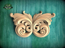 Load image into Gallery viewer, A decorative wooden butterfly with intricate scrollwork is displayed against a teal background.
