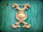 a decorative wooden carving on a green background.
