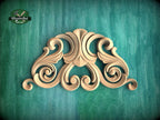 a decorative wooden carving on a green background.