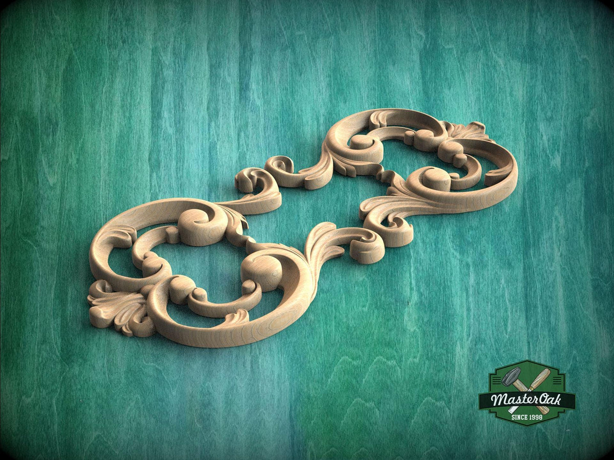 A decorative wooden carving with intricate scrollwork and floral elements is displayed against a green textured background.