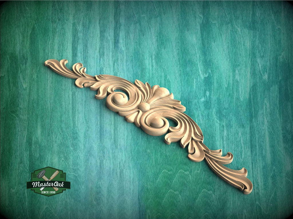 a wood carving of an ornate design on a green background