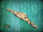 a wood carving of an ornate design on a green background