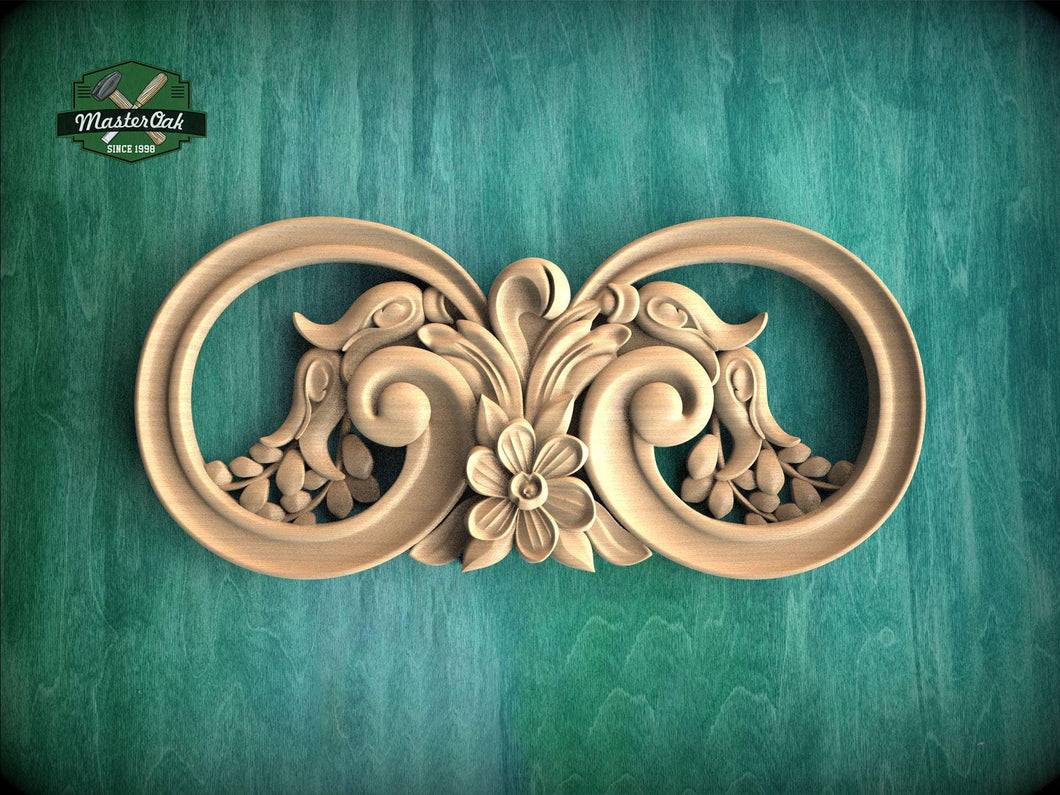 A decorative wooden carving with intricate floral and scroll designs, displayed against a green textured background.