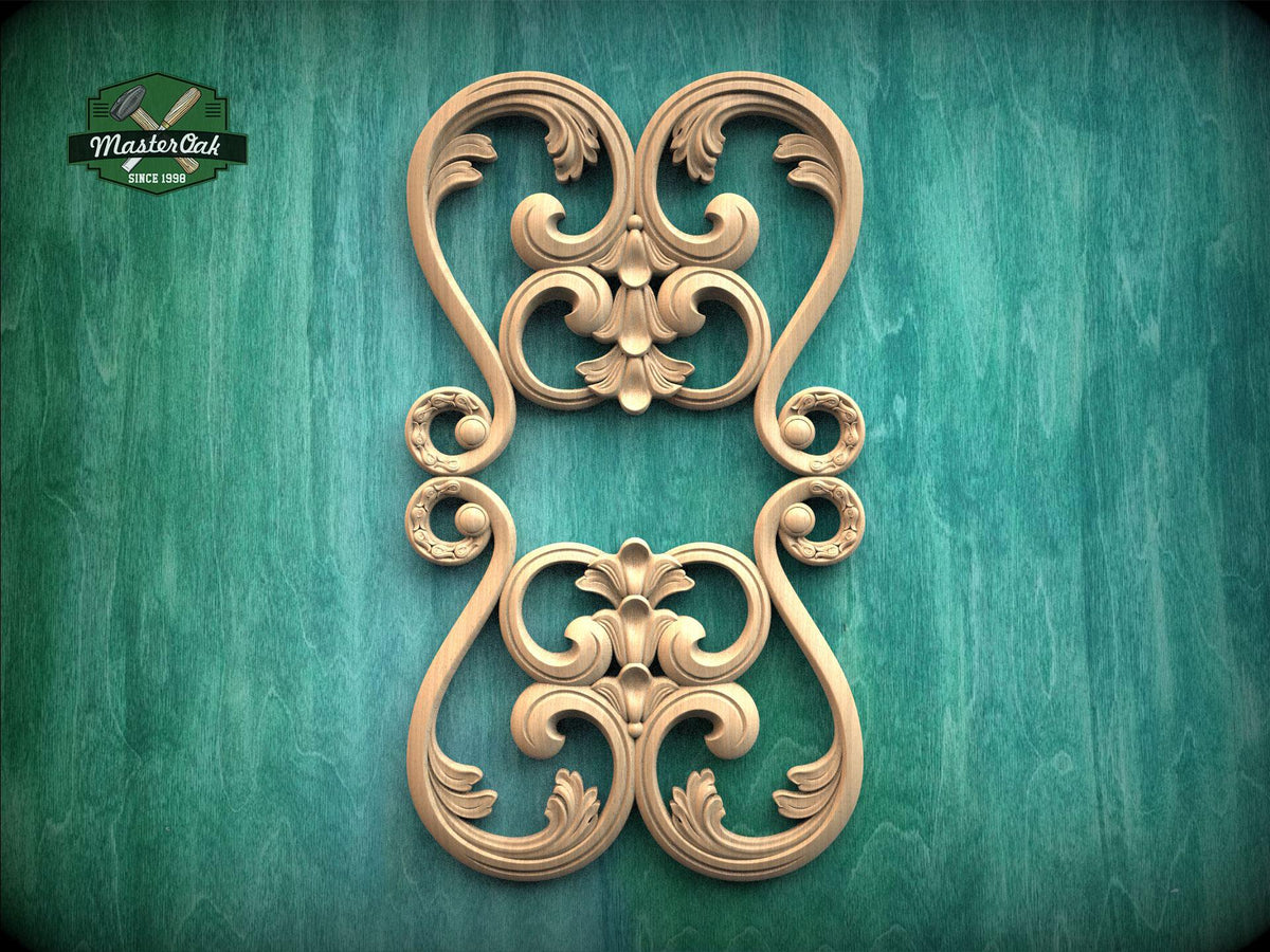 a decorative wooden carving with intricate scrollwork and floral designs, set against a green background.