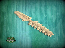 Load image into Gallery viewer, A decorative wooden leaf-like object is displayed against a green textured background.
