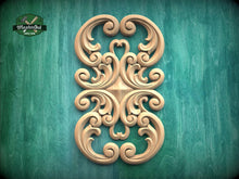 Load image into Gallery viewer, an ornate, carved wooden design with intricate scrollwork and swirls, set against a green background.
