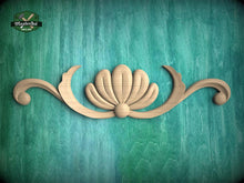 Load image into Gallery viewer, a decorative wooden carving of a shell on a teal background.
