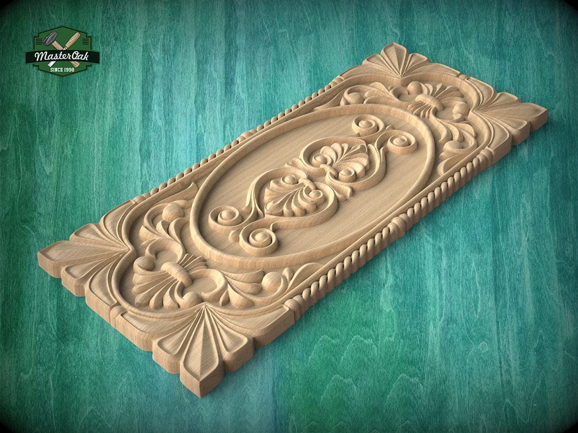 A wooden carving with intricate floral and scroll designs is displayed against a green background.