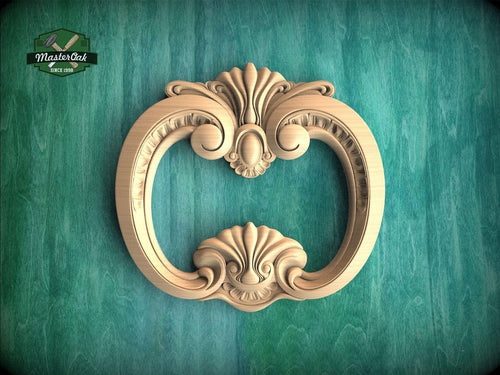 A decorative wooden frame with an ornate, floral design is displayed against a green background.