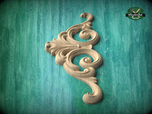 Load image into Gallery viewer, a decorative wooden carving on a teal background.
