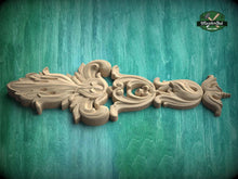Load image into Gallery viewer, A wooden carving with intricate, ornate designs is displayed against a green background.
