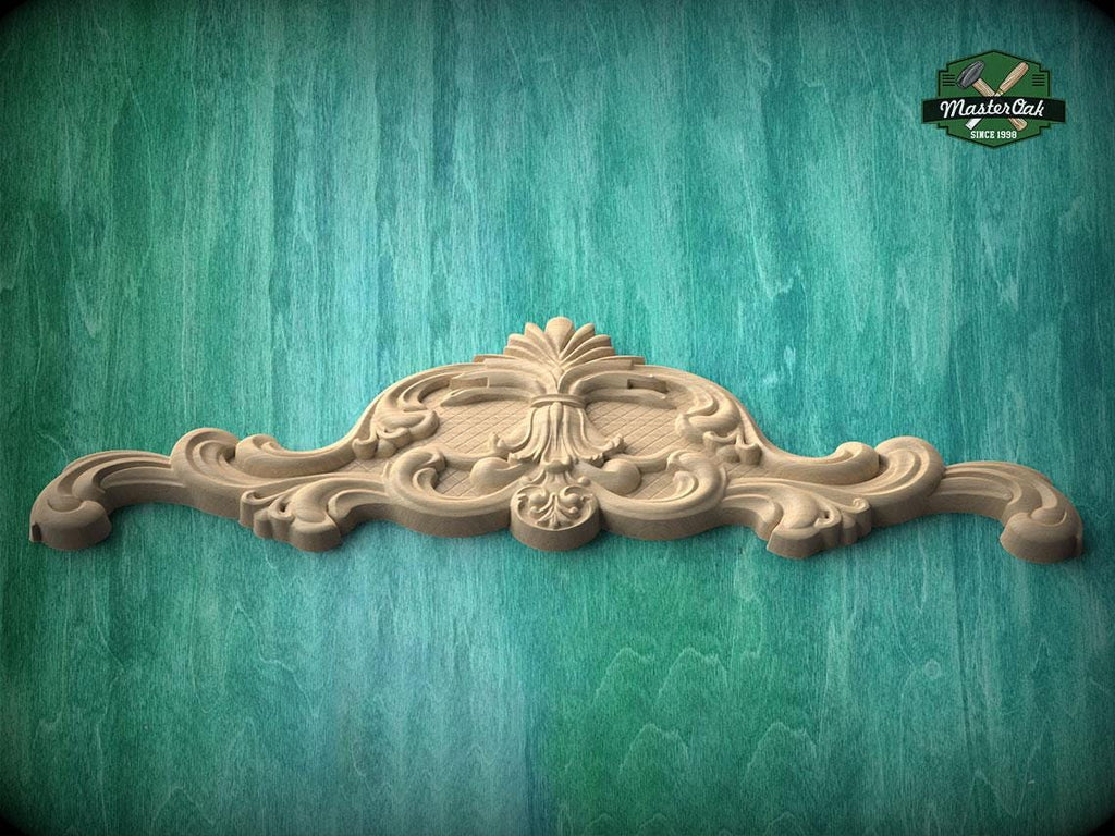 A decorative wooden mold or carving is displayed against a green wooden background.