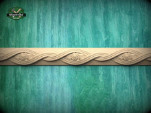 Load image into Gallery viewer, a decorative border made of wood, with a floral design on it, set against a green and blue background.
