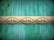 Load image into Gallery viewer, a decorative border made of wood, with intricate floral designs carved into it, set against a textured green background.
